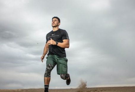 Fitness - Man Running on Sand Field