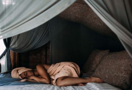 Sleep - Woman Lying on Bed wrapped around a Towel