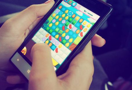 Mobile Games - Person Playing Candy Crush on Nokia Smartphone