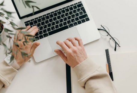 Productivity - Person in Beige Long Sleeve Shirt Using Macbook Pro