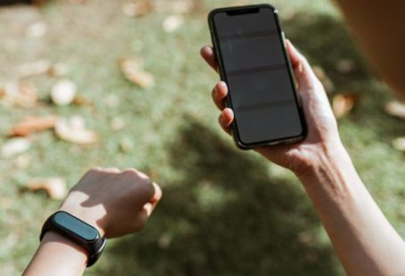 Heart Rate - Crop anonymous woman in smart watch surfing internet on smartphone