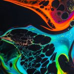 Liquid Cooling - Colorful mix of neon paints swirling on black surface