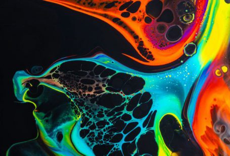 Liquid Cooling - Colorful mix of neon paints swirling on black surface