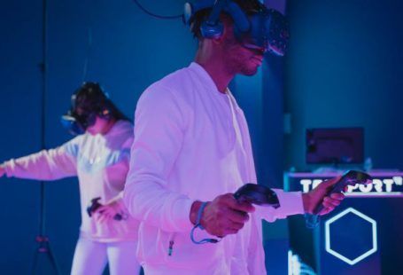 Controllers - Man Playing a Video Game while Wearing a VR Headset