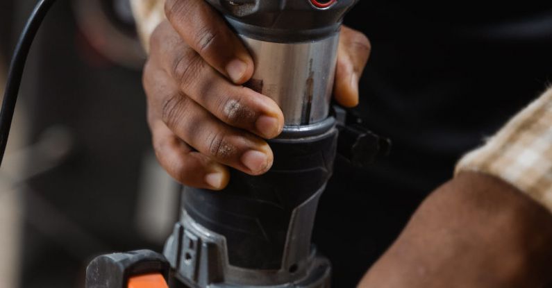 Routers - A Person Using a Compact Router on Wood
