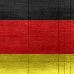E-textiles - Grungy background designed as flag of Germany on shabby wooden board with measure scale