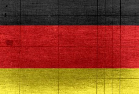 E-textiles - Grungy background designed as flag of Germany on shabby wooden board with measure scale